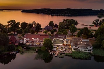 Hochzeitslocation: Außenansicht des Hotels mit Blick vom Küchensee. - Hotel Der Seehof  - Das Hotel im See