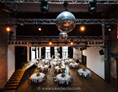Hochzeitslocation: Der Festssaal des Kesselhaus mit runden Tischen. - Events an der Alten Spinnerei