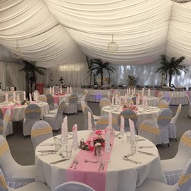 Hochzeitslocation: Ein dekorierter Hochzeitssaal in romantischen rosa mit direkten blick zum Wasser.  - Flasch City am Freizeitsee